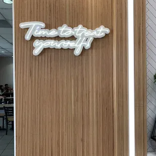 Cute neon sign inside next to the counter