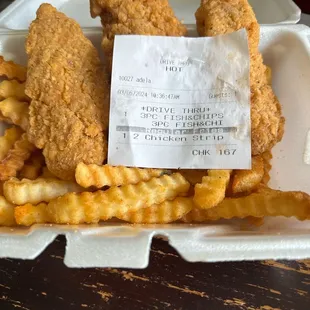 fried chicken and french fries in a styrofoam container