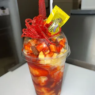 Mangonada... Mango Sherbet, mango cubes, topped with chamoy, powder chili and spicy gummies.