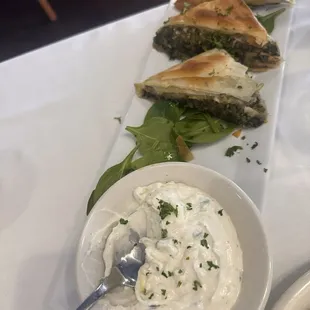 Spanikopita appetizer with tzatziki