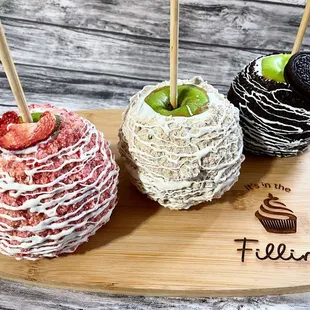 three chocolate covered apples