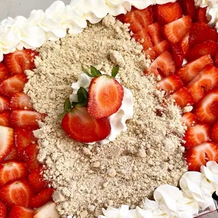 a cake with strawberries and whipped cream