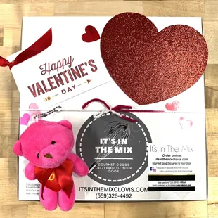 a pink teddy bear and a valentine card