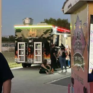a man standing in front of a food truck