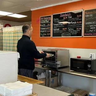 Owner Thomas making my hot bulgogi sandwich. The roll is toasted so it&apos;s blistered and a little chewy... and the cheese perfectly melted!