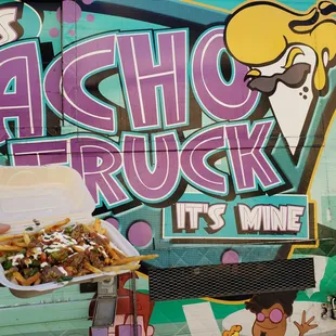 a hand holding a container of food