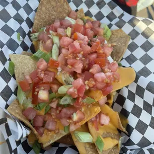 Kids nachos with tomatoes and onions added