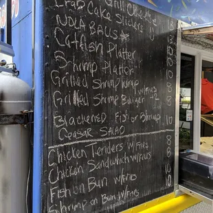 a menu on the side of a food truck