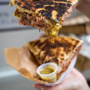 a person holding a sandwich