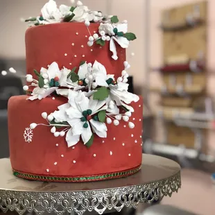 a red cake with white flowers
