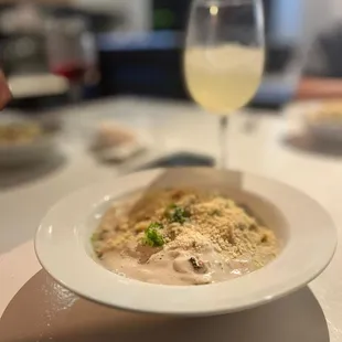 a plate of food and a glass of wine