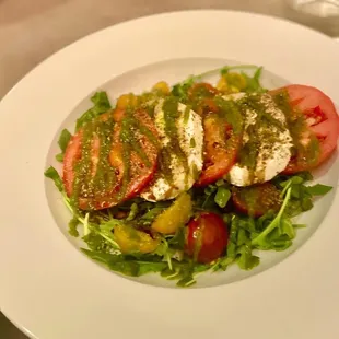 a plate of salad with tomatoes and mozzarella