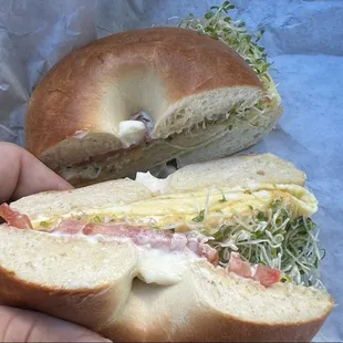 The breakfast sandwich #5 !  Egg ,tomato cheese mayo ,sprouts on a plain bagel