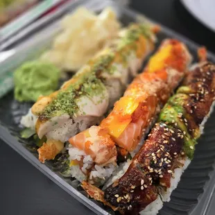 Assorted packed special sushi rolls to go.