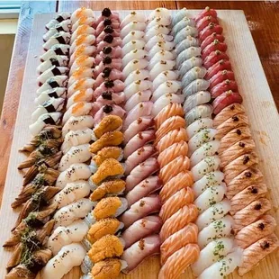 a variety of sushi on a cutting board