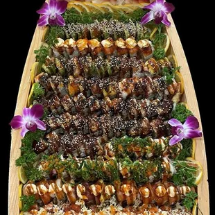 a wooden platter of sushi