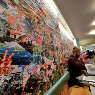 a restaurant with a wall covered in posters
