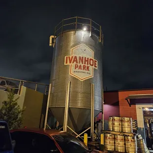 a car parked in front of a silo