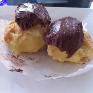 Chocolate eclair (torn in half by me) with the perfect amount of balance of filling, pastry, and frosting.