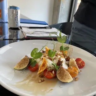 Burrata with figs, early girl tomatoes, honeycomb, saba, and pearls. Served with sourdough bread.