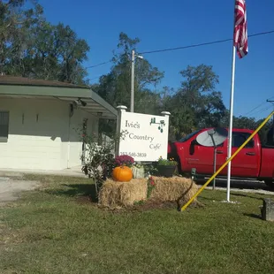 a red truck and a hay bale