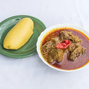 Palm nut stew with fufu plantain.