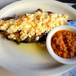Grilled tilapia and side tomato sauce