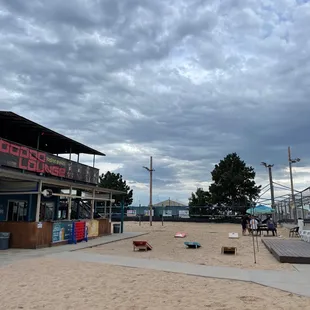 a sandy beach with lounge chairs