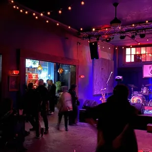 a band playing on stage in a dimly lit room