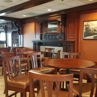 Courses Restaurant - seating area in front of fireplace and across from the bar