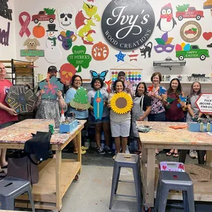 Friends gathering to paint and sip at Ivy's Wood Creations Studio in Roseville