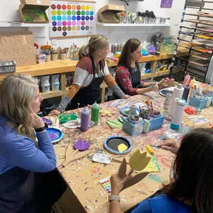 Book club meeting while painting together, paint and sip gathering.
