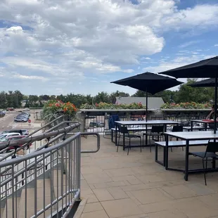 a patio with tables and umbrellas
