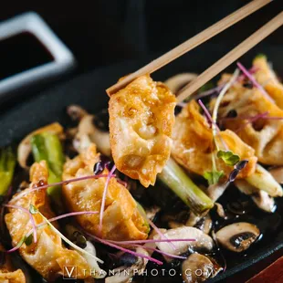 a plate of food with chopsticks