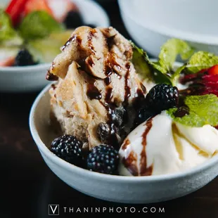 a bowl of ice cream and berries