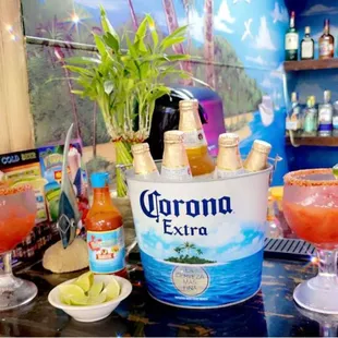 a bottle of coronana extra and a glass of margarita