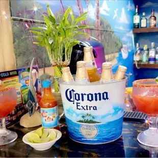 a bottle of coronana extra and a glass of margarita