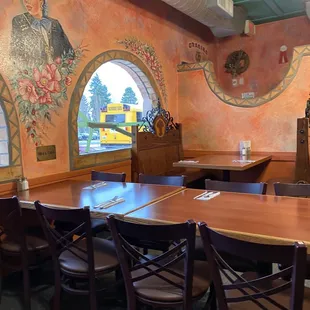 a dining room with a mural on the wall