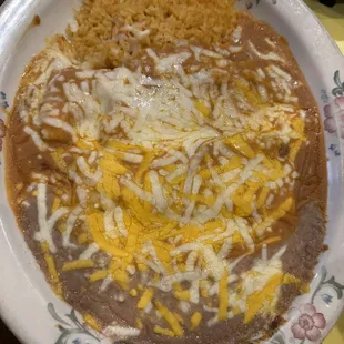 Tamale, enchiladas, rice, and beans