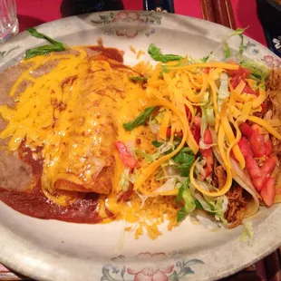 Enchillada with two tacos on soft corn tortillias. The black plate was the first thing I noticed...