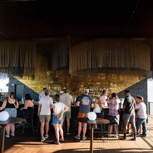 a group of people standing around a bar