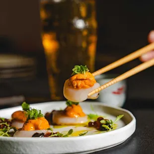 Ocean Umami
Scallop sashimi, ikura, uni nori puree, fermented plum green onion, wasabi leaf