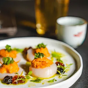 Ocean Umami
Scallop sashimi, ikura, uni nori puree, fermented plum green onion, wasabi leaf