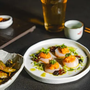 Ocean Umami
Scallop sashimi, ikura, uni nori puree, fermented plum green onion, wasabi leaf