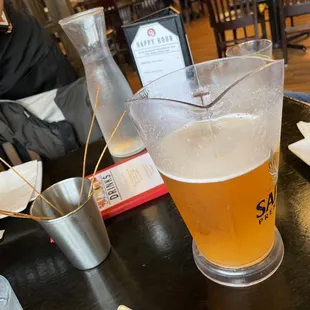 Crunchy spaghetti sticks and pitcher of Sapporo