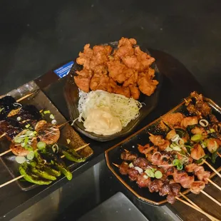 a variety of food on skewers