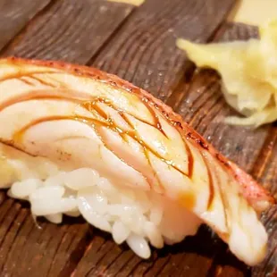 a piece of sushi on a wooden board
