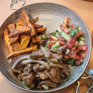 Grilled lamb with Israeli salad and sweet potato fries. The empty space was the hummus.  I got it on a separate plate.