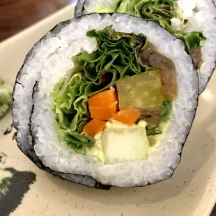 two sushi rolls on a plate