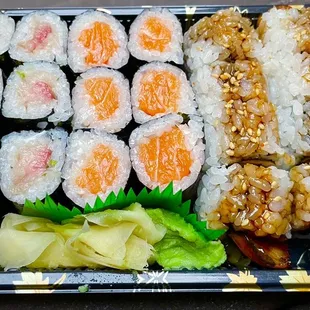 a plate of sushi and vegetables